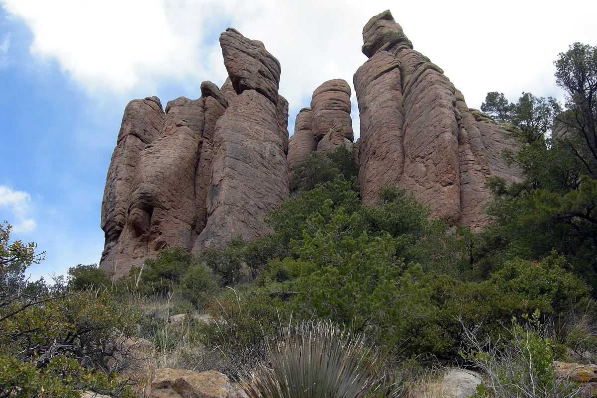 Rhyolite hoodoos and desert scrub under a blue sky at Chiricahua