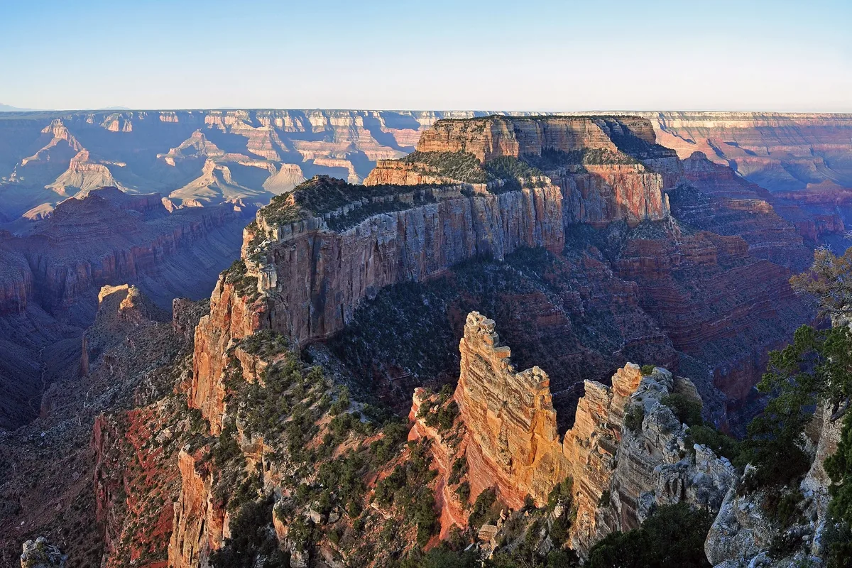 Muted sunrise over canyon ridges from Cape Royal on the North Rim of the Grand Canyon