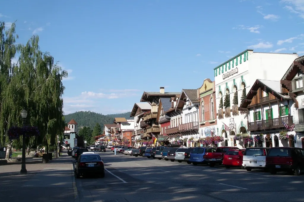 Bavarian-style storefronts line Front Street in Leavenworth, Washington, with forested hills behind
