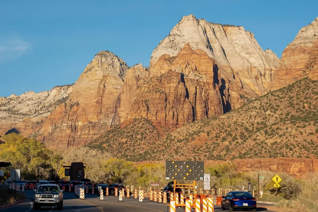 Golden sandstone peaks rise above the south entrance road of Zion National Park, Utah